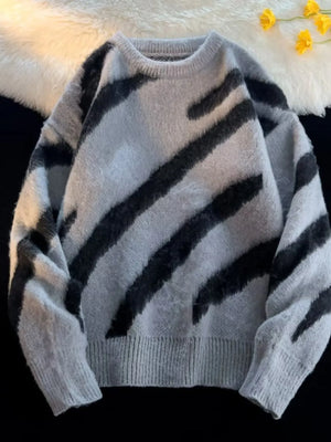 Oversized fuzzy knit pullover sweater in grey with black abstract stripes.