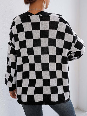 Checkerboard knit cardigan in black and white with balloon sleeves.