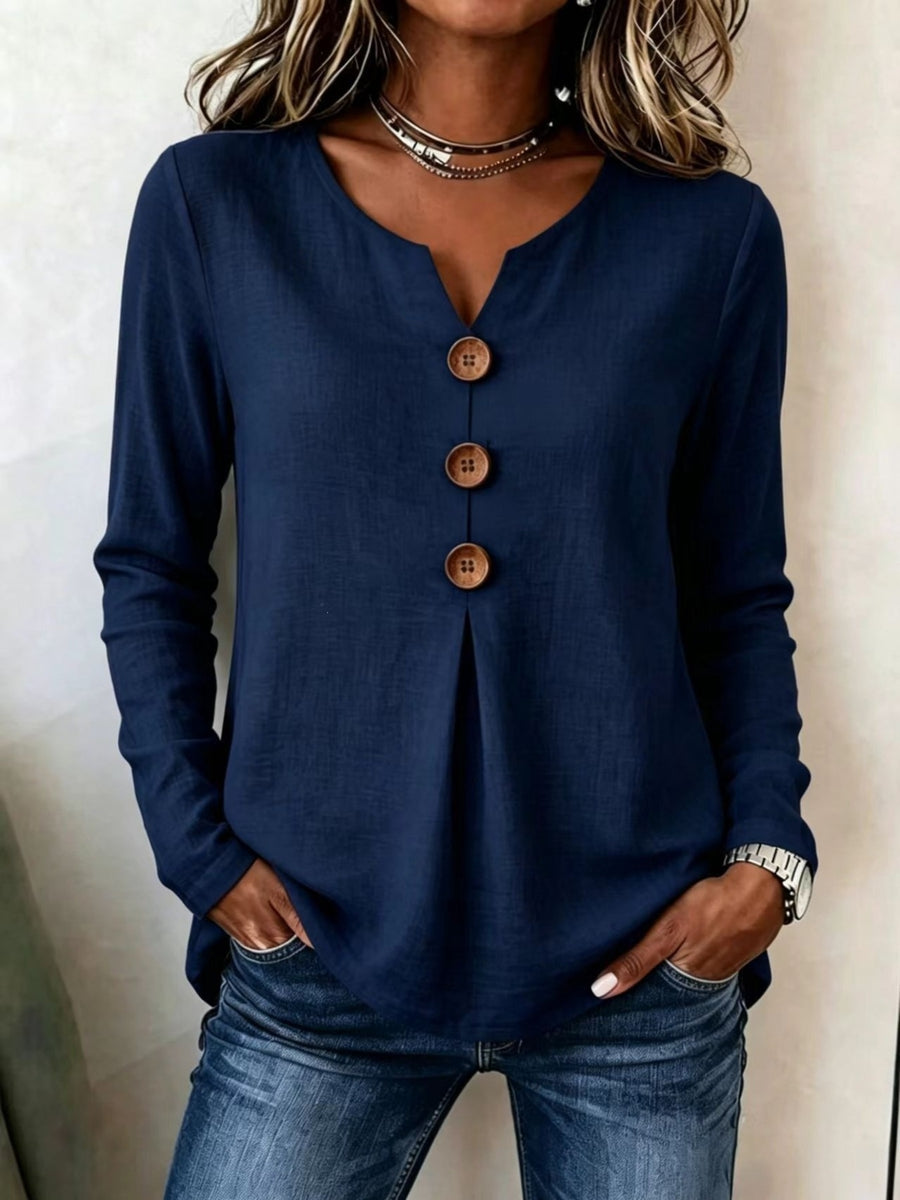 blouse in light blue with decorative buttons and hip-length