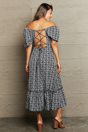 Black floral midi dress with smocked bodice and lace-up back detail