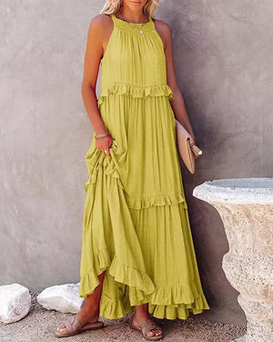 Yellow ruffled maxi dress with halter neck and tiered skirt.