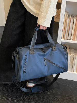 Blue travel organizer bag with padded strap and multiple zippered pockets.
