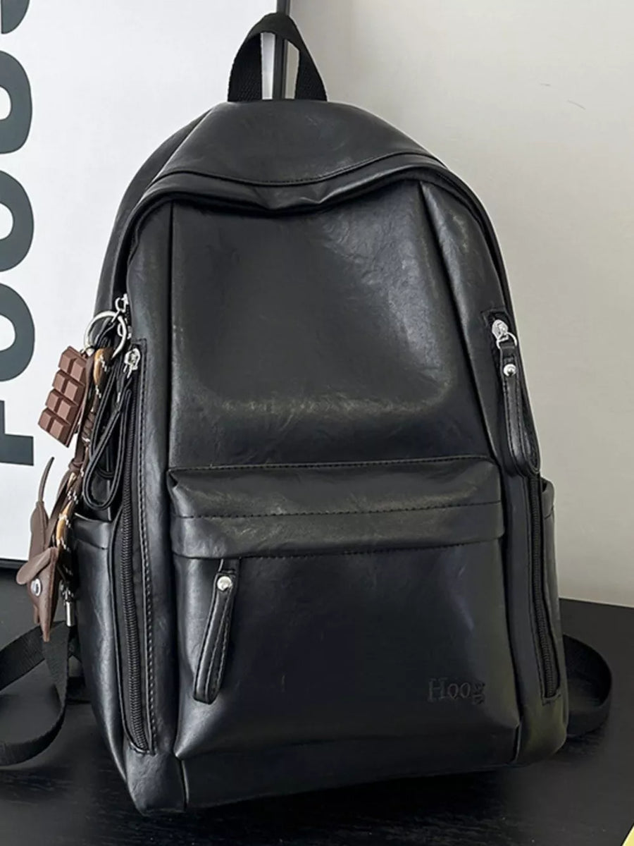 Chic black pu leather medium backpack with multiple zippered pockets and chocolate bar keychain.