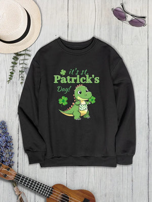 Black St. Patrick's Day sweatshirt with a cartoon dinosaur holding shamrocks and text.