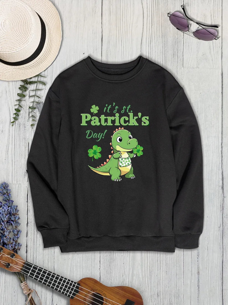 Black St. Patrick's Day sweatshirt with a cartoon dinosaur holding shamrocks and text.