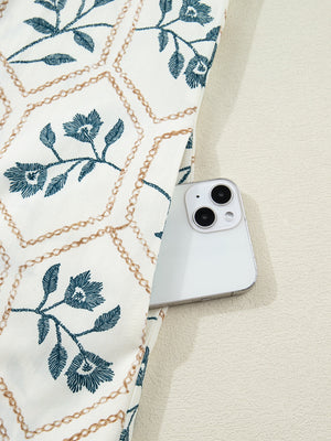 Floral print mini dress with polo collar and button detail, showing a side pocket holding a phone.