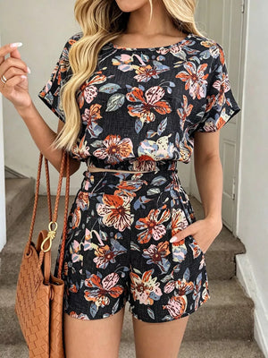 Floral two-piece set in navy blue with crop top and shorts, featuring pockets.