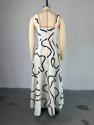 White midi dress with abstract black pattern, square neck, and thin straps.