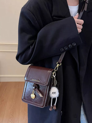 Caramel pu leather crossbody bag with charm and gold detail