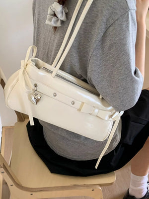 White PU leather shoulder bag with heart charm and bow detail