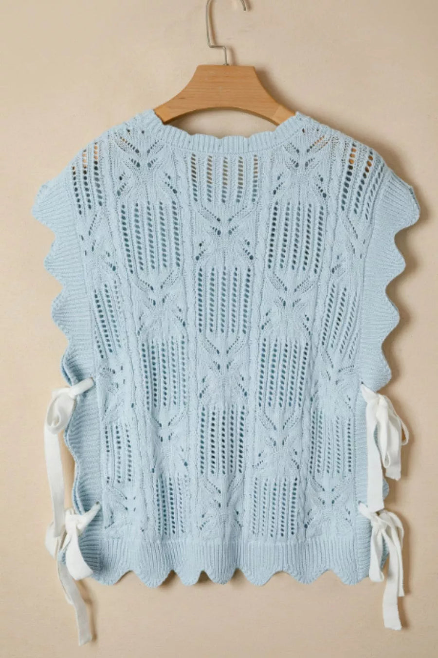 Light blue openwork cable-knit cardigan with cap sleeves and tie details