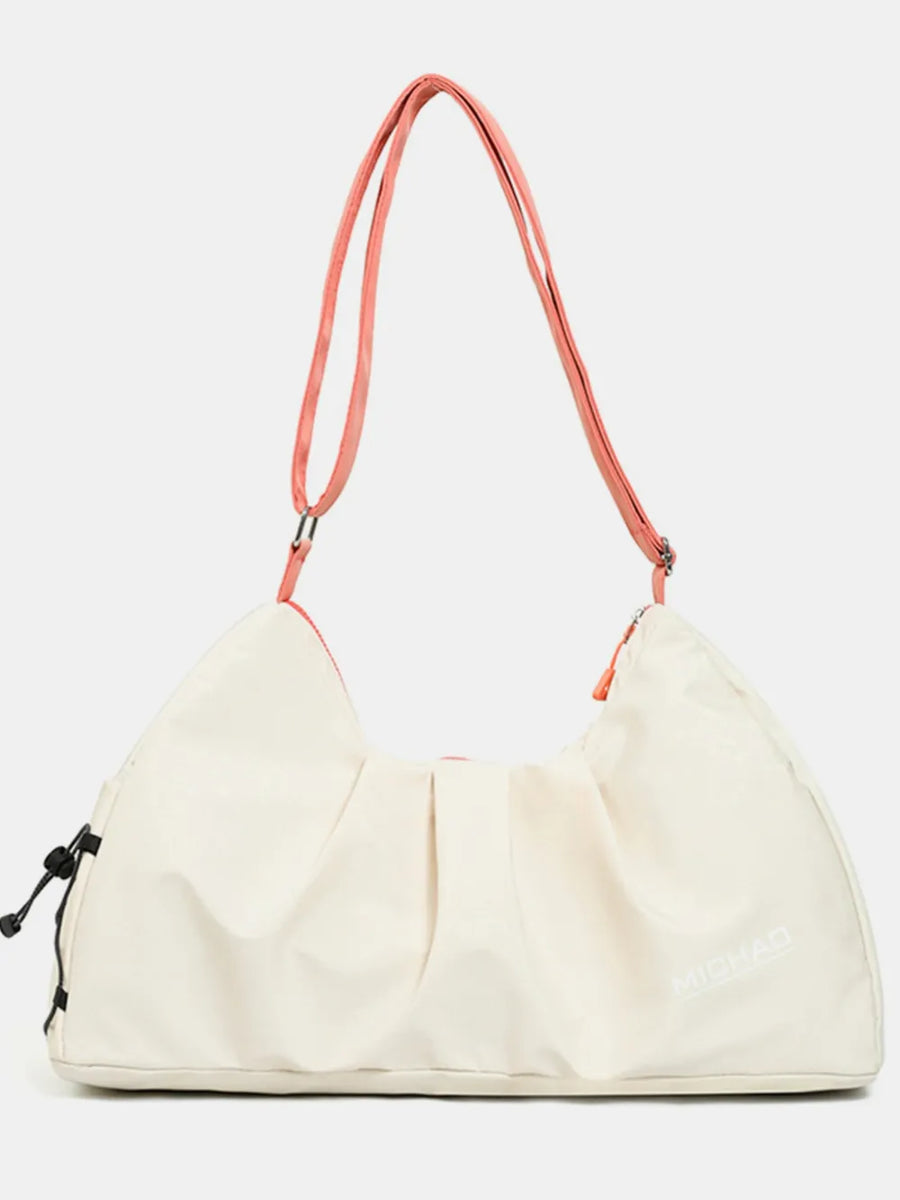 Gathered pleat crossbody bag in beige with pink straps and drawstring detail.