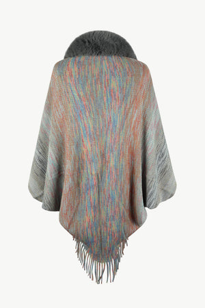 Textured knit cape with faux fur collar and fringe hem, featuring a multicolor stripe pattern.