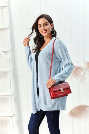 Light blue cable knit open front cardigan with detailed sleeves.