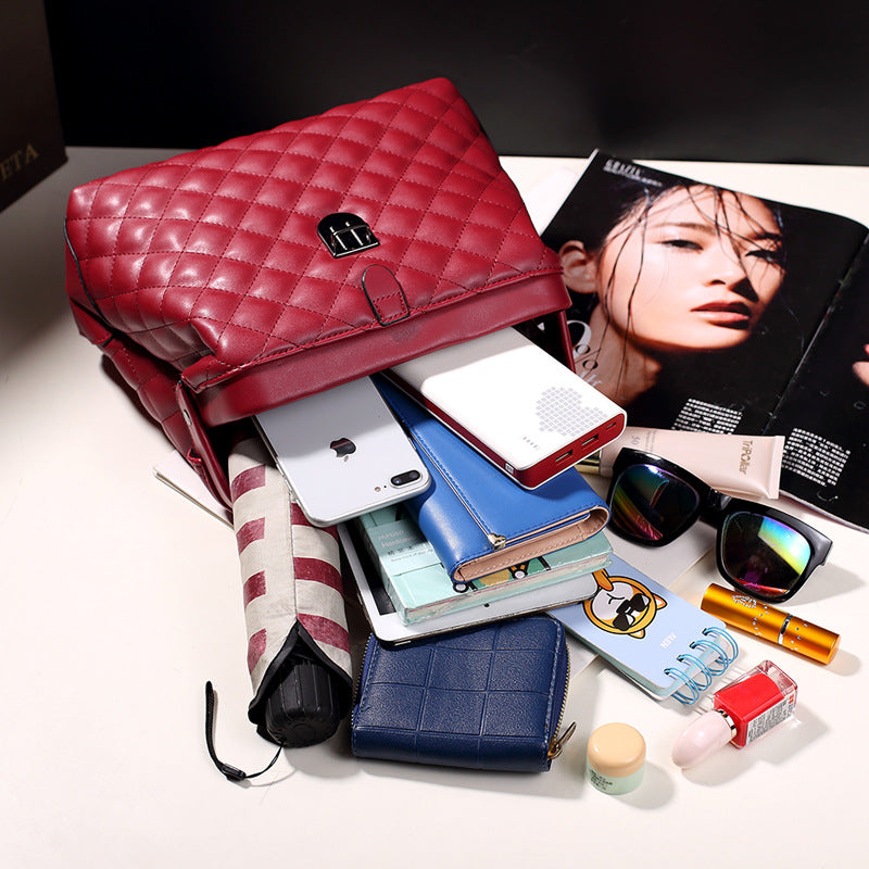 Red handbag featuring quilted and quilted