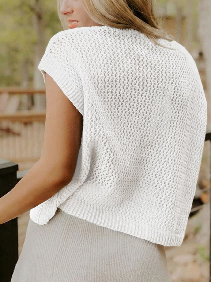 White acrylic knit short-sleeve sweater with open knit pattern and ribbed hem