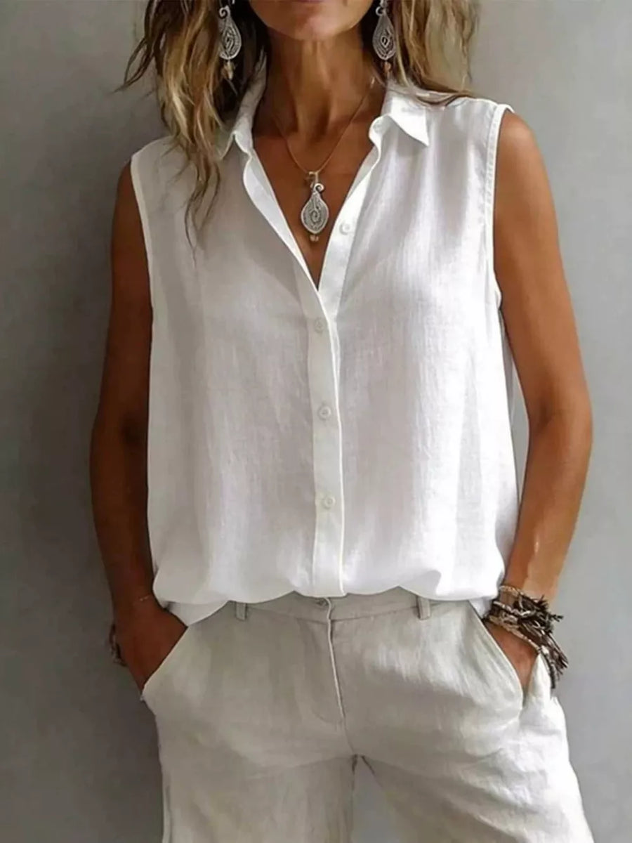 White sleeveless button-up shirt with a collared neckline and a relaxed fit.