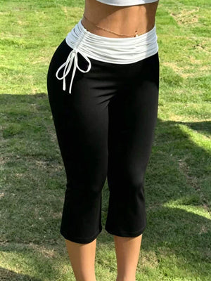 94% polyester, 6% elastane Care instructions: Machine wash cold capri pants in Black with slim silhouette