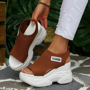 Brown open-toe wedge sandals with chunky white soles and "Fashion" detail.