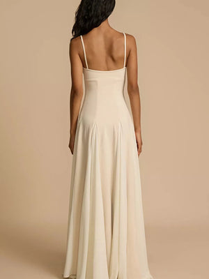 Elegant ivory sweetheart neck maxi dress with spaghetti straps and flowing skirt.