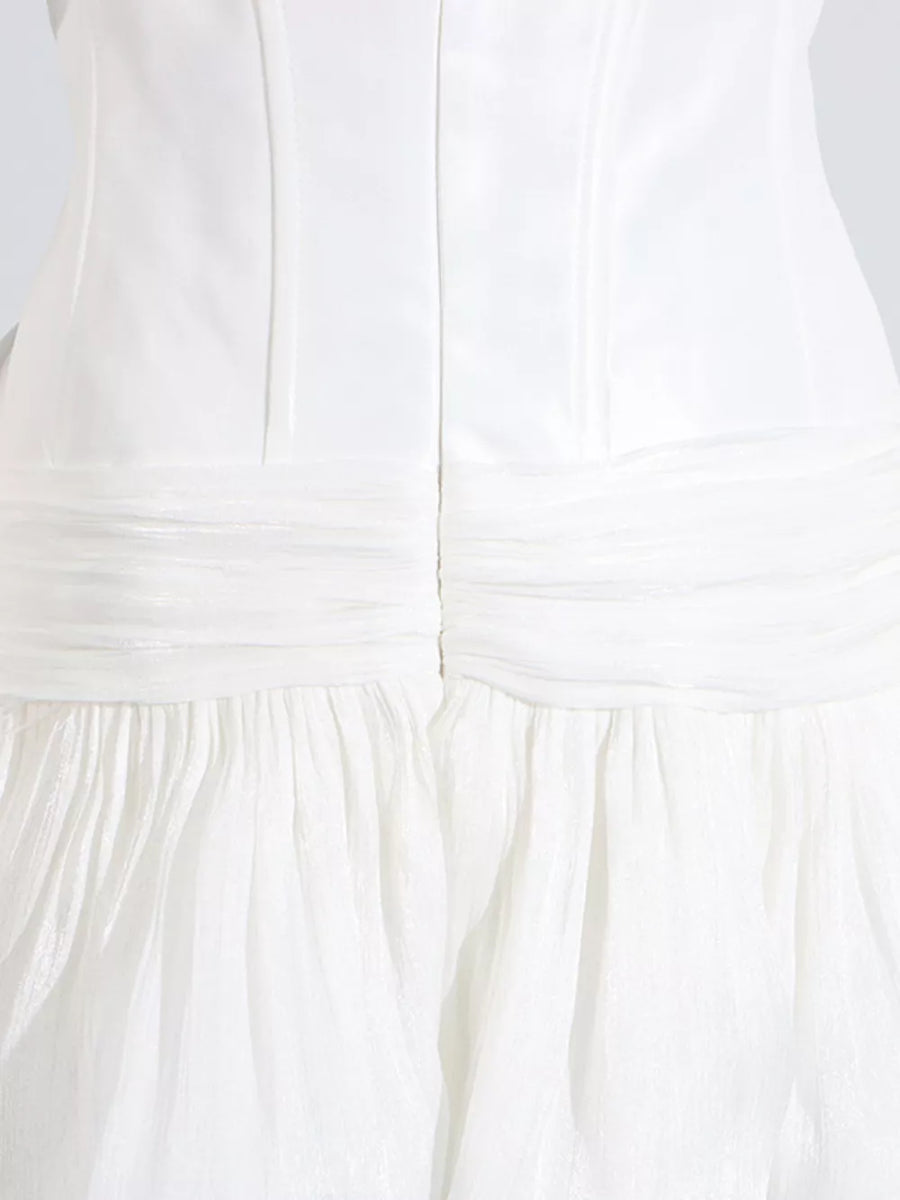 White mini dress with ruched bodice and tiered ruffled skirt.