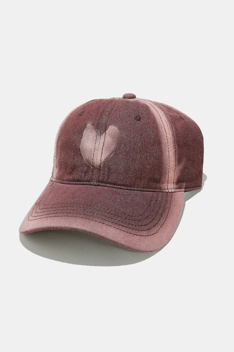 Bleached heart baseball cap in dusty pink with a faded effect.