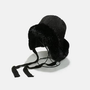 Black trapper hat with faux fur trim and tie straps