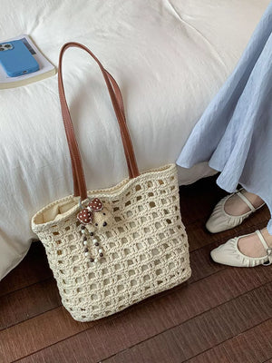 handbag in cream featuring woven construction and tote fit