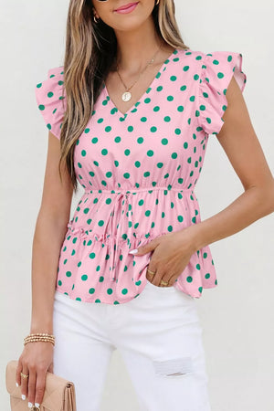 Pink polka dot blouse with ruffled sleeves, drawstring waist, and tiered hem.