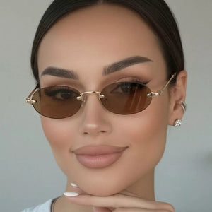 metal Frame material: Metal Lens material: Polycarbonate Temple material: Metal sunglasses in Tan with oval silhouette