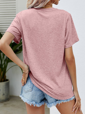 Dusty Pink heathered t-shirt with short sleeves and a relaxed fit, paired with denim shorts.
