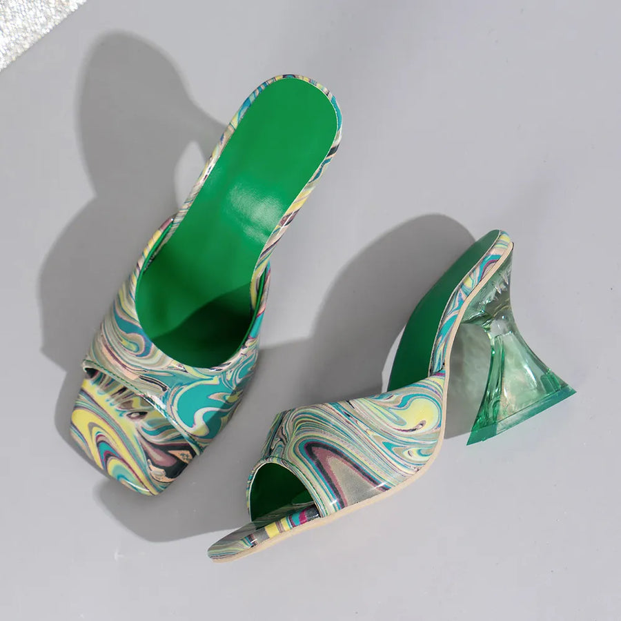Swirl print lucite heel mules with open toe and green insole.