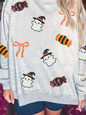 white sweatshirt featuring sequin embellishment and graphic