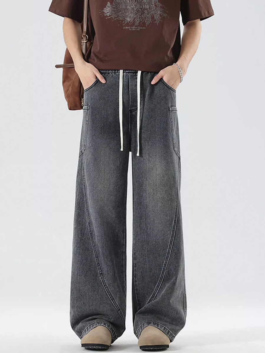 Oversized wide-leg jeans in smoky gray denim with a drawstring waist and vintage-inspired stitching.