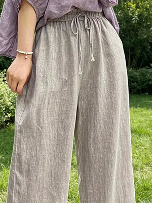 Khaki maternity pants with drawstring waist and pockets.