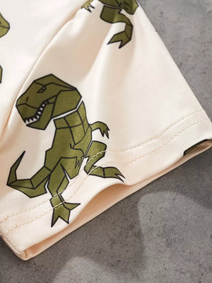Cream cotton tee with allover green geometric dinosaur print.
