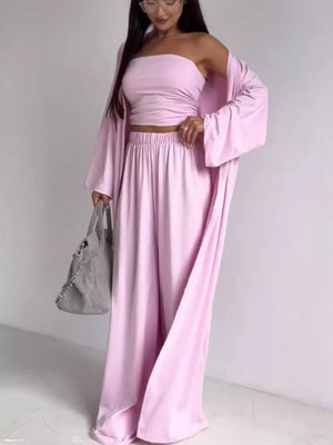 Blush pink three-piece maternity set with ruched bandeau crop top, wide-leg pants, and open cardigan.