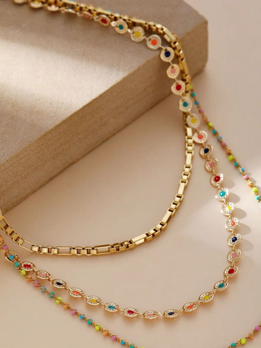 Gold necklace featuring layered design and beaded