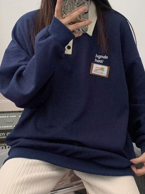 Navy waffle-knit polo sweatshirt with button detail and embroidered patch