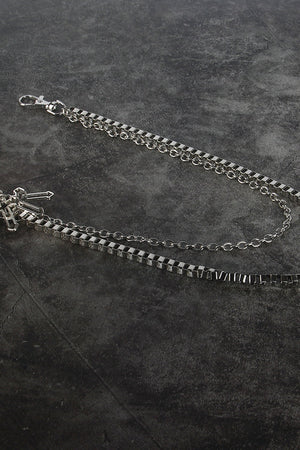 Silver geometric chain waist accessory with crossed charms and lobster clasp.