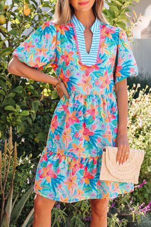 Tropical floral v-neck tiered dress with scalloped trim and puff sleeves.