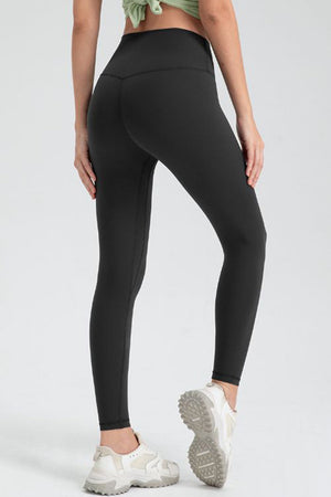 Black high-waist performance leggings with sculpted seams and a V-cut back detail.