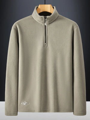 Khaki fleece quarter zip sweatshirt with a mock neck and embroidered logo detail.