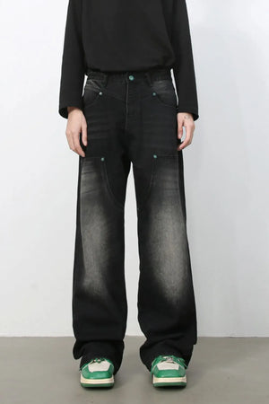 Faded wash wide-leg carpenter jeans in dark black with green button details.
