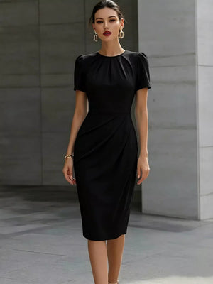 Black midi dress with ruched waist and pleated asymmetrical skirt