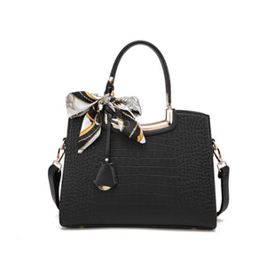 Black crocodile-embossed tote with decorative scarf and detachable strap