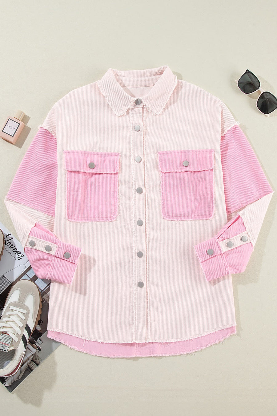 Colorblock corduroy shacket in blush pink with raw edges and buttoned chest pockets.