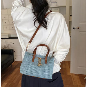 crossbody bag in dusty blue with woven texture and small