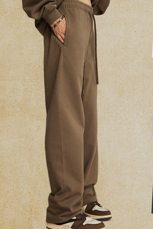 Relaxed fit lounge trousers in Tan with drawstring waist and pockets.