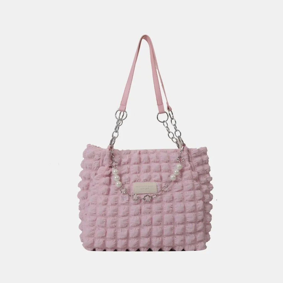 Blush pink textured shopper bag with pearl chain detail and silver hardware.